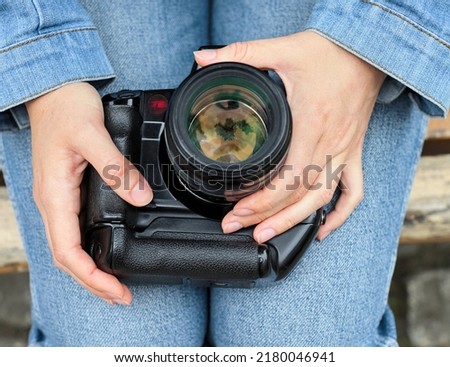girls holding analog film camera
