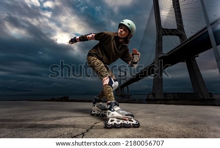 Roller skating teen in outdoors rollerblading on inline skates. Caucasian young girl in outdoor activities. Royalty-Free Stock Photo #2180056707