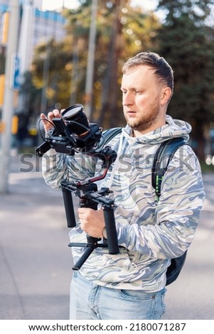 Professional videographer with gimball video setup during shooting