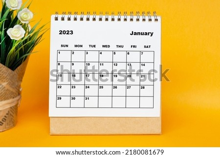 White January 2023 calendar with potted plant on yellow background. 2023 New Year Concept Royalty-Free Stock Photo #2180081679