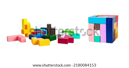 Chaos vs order concept. Multicolored puzzle toy elements and blocks arranged in cube isolated on white background. Wooden kids game for logical thinking development. High quality photo Royalty-Free Stock Photo #2180084153