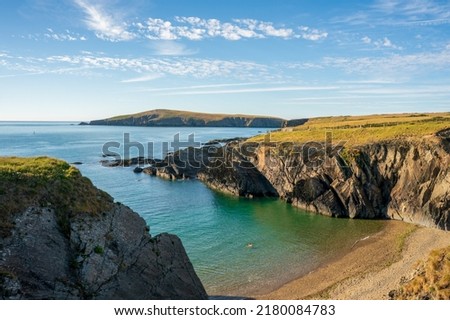 A landscape view of  the coast of  cardigan  bay with the island in the distance  in West Wales Royalty-Free Stock Photo #2180084783