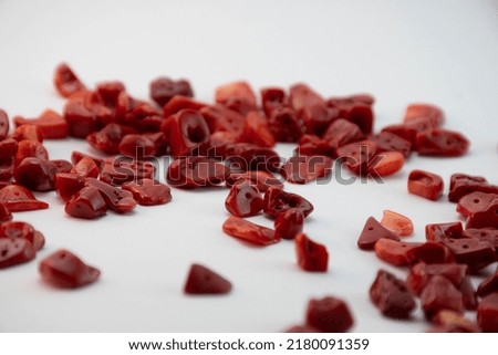 Shiny different natural red corals close up on a white background. Isolated jewelry
