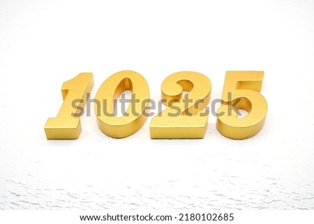   Number 1025 is made of gold painted teak, 1 cm thick, laid on a white painted aerated brick floor, visualized in 3D.                               