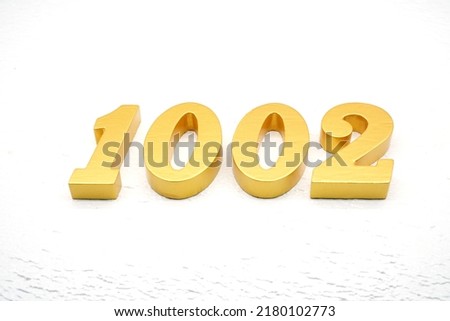 Number 1002 is made of gold painted teak, 1 cm thick, laid on a white painted aerated brick floor, visualized in 3D.                                  