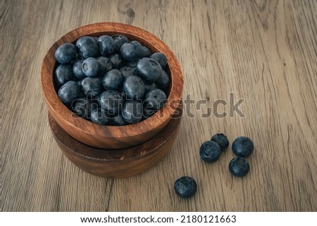 Blueberry on wooden table background. Ripe and juicy fresh picked blueberries closeup. Berries closeup
