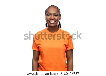 people, ethnicity and portrait concept - happy young woman over white background