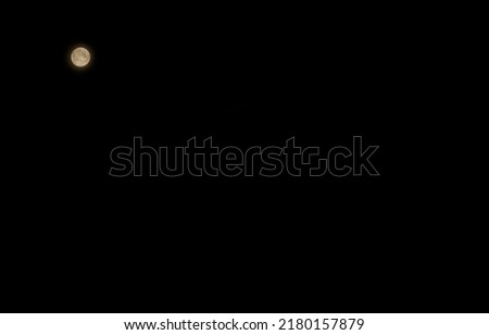 The moon against the black sky. Abstract background