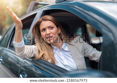 Road rage traffic jam concept. Businesswoman is driving her car very aggressive Royalty-Free Stock Photo #2180167973
