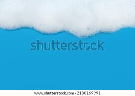 Soap foam. Background of dusty foam with bubbles of blue color for an inscription. Soap sud with copy-space Royalty-Free Stock Photo #2180169991