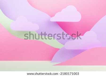 Fantasy cartoon landscape as abstract scene mockup with paper pink clouds, mountains in pink, lilac, white color. Background for advertising, design, card, presentation of cosmetic, goods, poster.