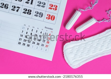 Woman hygiene protection, menstruation calendar and clean cotton tampons and gasket pad