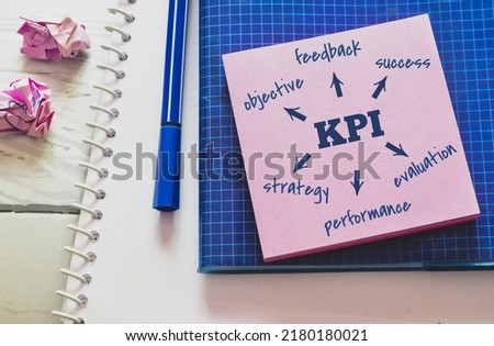 Sticky note with the KPI (Key Performance Indicator) flowchart on office desk. Guidance concept.