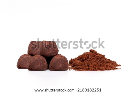 A slide of chocolate candies truffle and cocoa powder, isolate on a white background