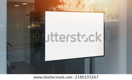 Horizontal blank lightbox with mockup fixed behind window case glass of shop or restaurant