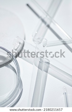 Test tubes, petri dish and glass rods in the laboratory on white background. Science research. Laboratory glassware close up. Transparent container. Medicine and beauty concept. Royalty-Free Stock Photo #2180211657