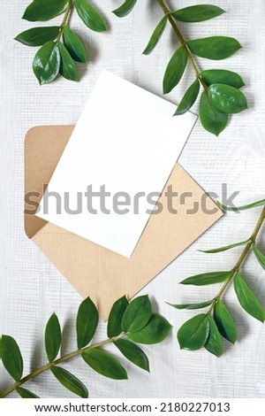 Mock up card with plants. Invitation card with envelope on white background.
