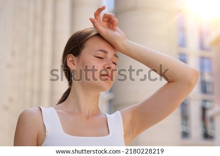 portrait of tired sick exhausted woman, beautiful girl is suffering from hot Summer heat stroke, sunshine, hot weather day, sweaty and thirsty, high temperature. Feeling unwell, unhealthy Royalty-Free Stock Photo #2180228219