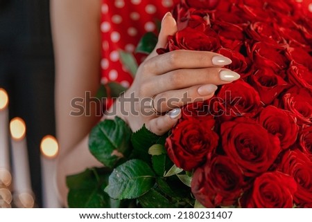 Picture of man putting engagement silver ring on woman hand.