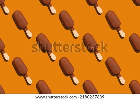 seamless pattern of a cold and delicious chocolade glazed eskimo on an orange background