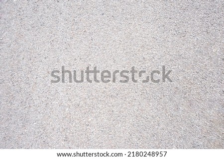 Granular soil texture with gravel particles, small stones, black, gray and white grains. Close-up, top view. Gray asphalt pattern. Bitumen road texture Royalty-Free Stock Photo #2180248957