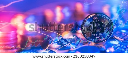 Golden bitcoin coin in neon light with bull trading stock chart.Bitcoin Gold and Cash lightning blockchain hard fork concept.Cryptocurrency coin on polygon peer to peer network background. 