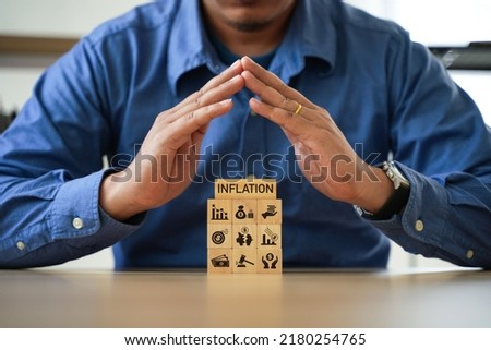 man with wooden blocks A company's recession solution or inflation business idea.