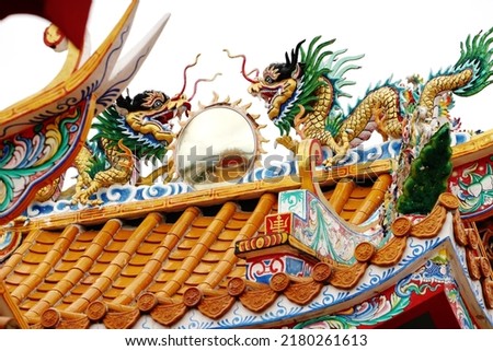 Decorative of the ceramic dragon statue on the top of roof in Chinese temple