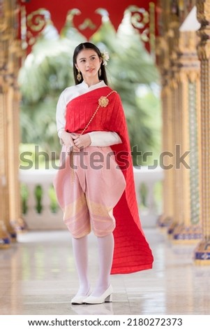 Portrait of a beautiful thai woman wearing a thai dress,Thai girl in retro Thai dress,Beautiful Thai girl in traditional dress costume Royalty-Free Stock Photo #2180272373