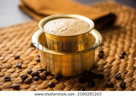 South Indian Filter coffee served in a traditional brass or stainless steel cup Royalty-Free Stock Photo #2180281263