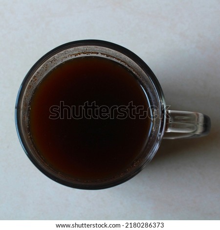 Isolated a glass of black coffe from top angle on white background.