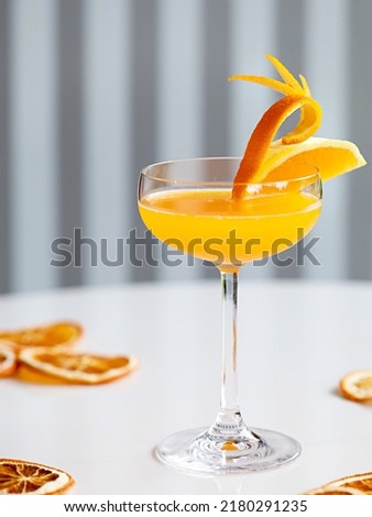 " Yuzu orange daiquiri " cocktail in coupe glass with dried orange  Royalty-Free Stock Photo #2180291235