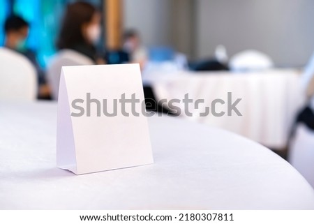 Triangular shaped table sign is placed on the table for scanning QR codes as an announcement, reservation sign, or menu at the seminar. Royalty-Free Stock Photo #2180307811