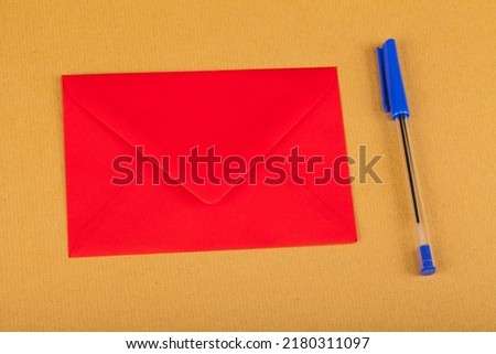 Red envelope  with a pen on a yellow background