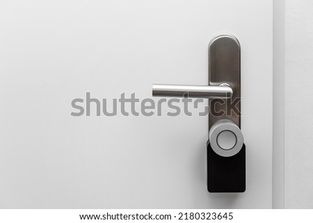 Electronic door handle installed on wood door. Door with digital door lock systems best security protection for apartment. 