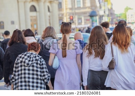 People walk down the street in the city during the day