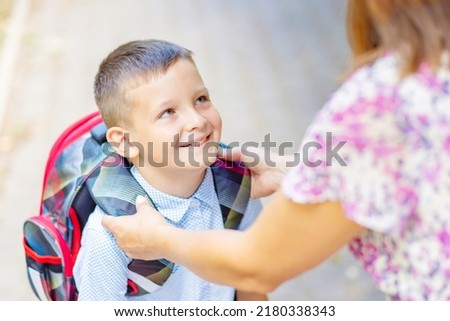 Back to school. Schoolboy is ready go to school. Cute child with a backpack outdoors. First day at school. Royalty-Free Stock Photo #2180338343