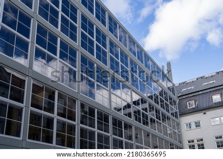 Reflecting Window Glass on Symmetric Modern building brick facade in Downtown of Copenhagen, Denmark, Scandinavia.