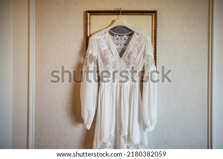 Lace wedding dress hanging in the picture.