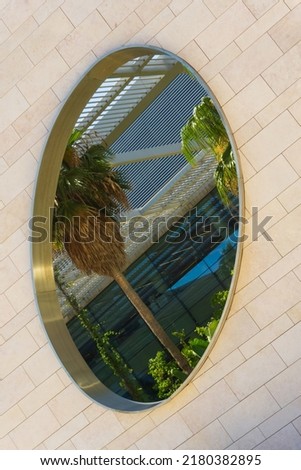 A modern building with tropical plants and palm trees inside