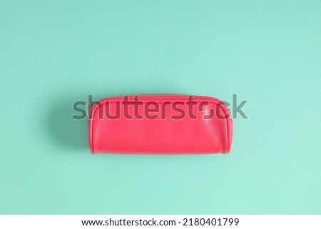 Pink school pencil case on mint background. Back to school. Flat lay, top view, copy space Royalty-Free Stock Photo #2180401799