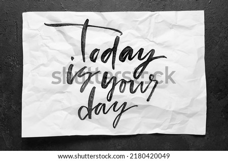 Today is your day. Lettering on crumpled white paper. Handwritten text. Inspirational quotes.