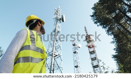 Telecommunications engineer turns to the radio antennas Royalty-Free Stock Photo #2180425179