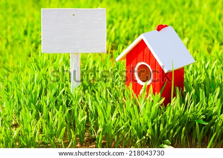  Red house and signboard on grass