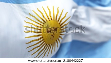 Close-up view of the national flag of the Argentine Republic. South American country. Horizontal triband of light blue (top and bottom) and white with a Sun of May centered on the white band. Royalty-Free Stock Photo #2180442227