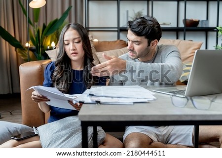 business debt problem home finance failure,husband and wife discussing paper bill payment receipt together with stress and confused feeling with many problem and debt home interior background