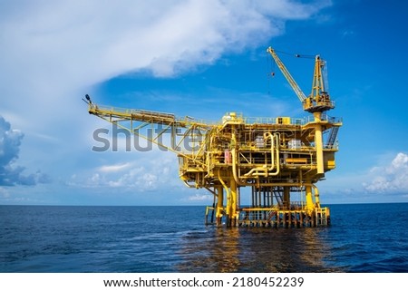 Offshore oil and gas wellhead remote platform which produced raw material for sent to onshore refinery, power generation and petrochemical industry. Royalty-Free Stock Photo #2180452239