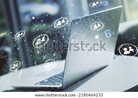 Double exposure of social network icons concept with world map and modern laptop on background. Marketing and promotion concept