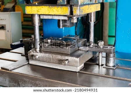Automation hydraulic press stamping machine production line. industrial metalworking machines. Close-up of a hydraulic press in an industrial workshop at a factory Royalty-Free Stock Photo #2180494931