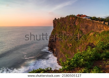 Sunset at beach with cliff and blue sky